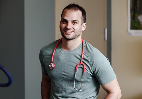 Male student with stethoscope around his neck